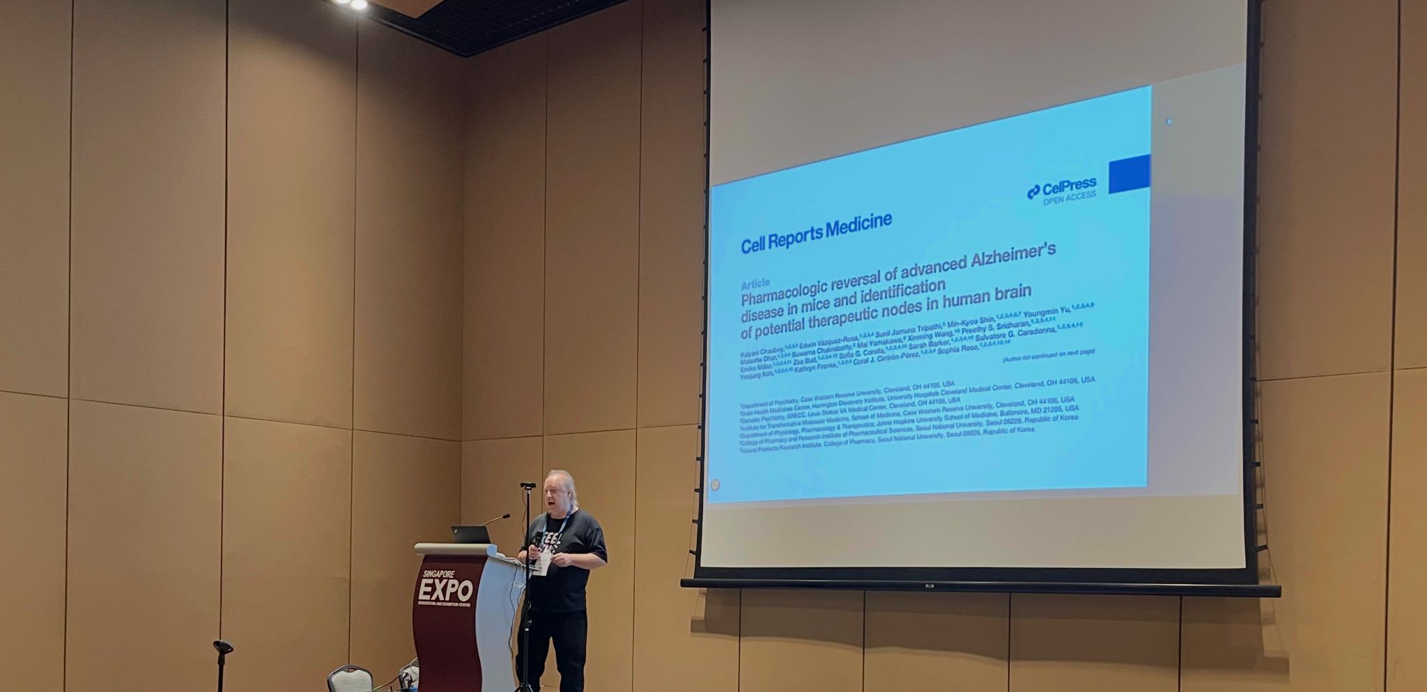 David Scott Lewis presenting the Cell Reports Medicine Alzheimer's reversal paper at AAAI-26 Singapore Expo